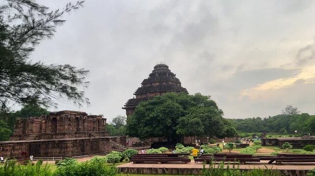 Konark Sun Temple Surrounded by Lush Green Trees and Landscape. Ancient Stone Carvings and Architecture at Konark Sun Temple Site.