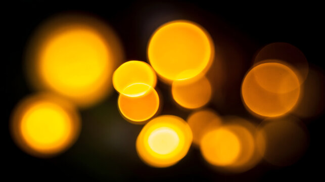 Abstract golden bokeh circles create a warm and enchanting atmosphere in this artistic image.
