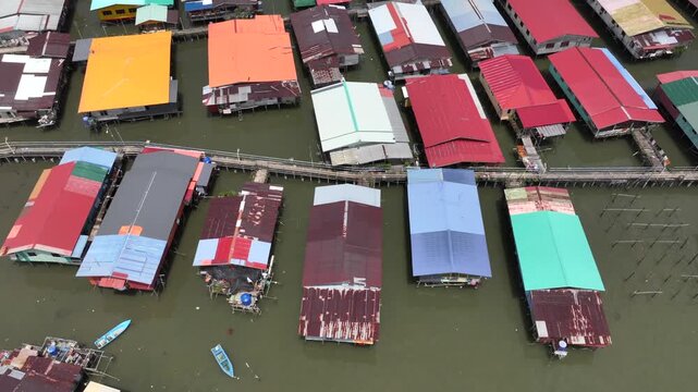 Stilt Houses Above Sea Waters. Traditional Bajau Laut Village, Sea Gypsy people in Sandakan, Sabah, Borneo, Malaysia. 