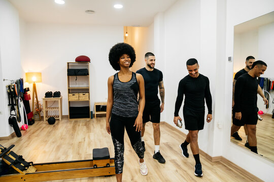 Friends enjoying a fitness session in a modern gym