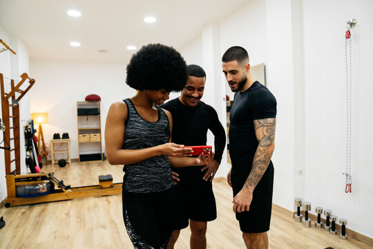 Friends enjoying a workout session in the gym