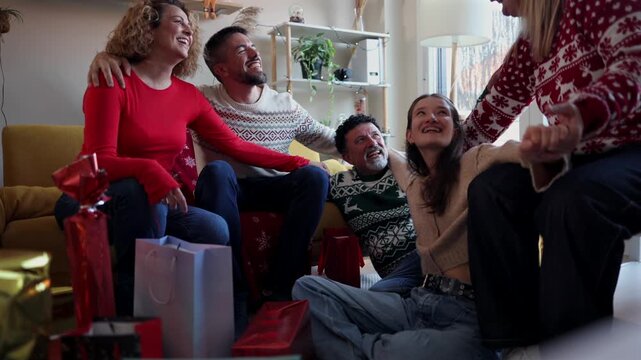 Joyful family gathering in a cozy living room, sharing laughter and exchanging presents on christmas morning, celebrating the holiday season together in a festive and warm atmosphere
