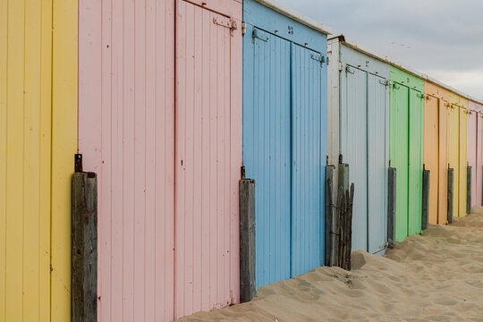 abstract row of pastel colored beach huts or cabins background