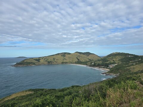 Panoramic high angle view of Praia Brava crescent bay with green hills, sandy beach and islands in Armacao dos Buzios, Rio de Janeiro, Brazil.