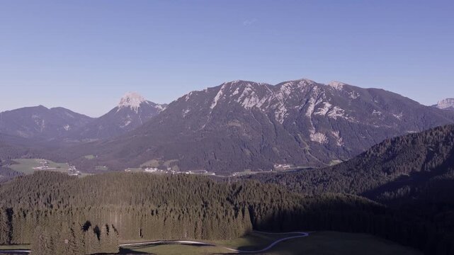 Aerial View of Alpine Farmhouses Framed by a Dramatic Mountain Range. Achenkirch, Austria