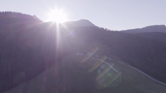 Aerial View of Alpine Farmhouses Framed by a Dramatic Mountain Range. Achenkirch, Austria