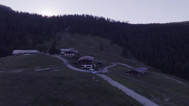Aerial View of Alpine Farmhouses Framed by a Dramatic Mountain Range. Achenkirch, Austria