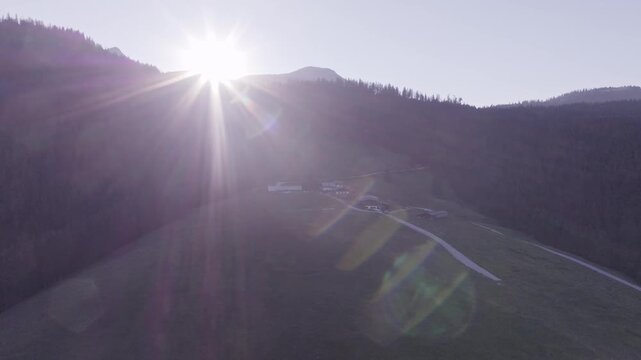 Aerial View of Alpine Farmhouses Framed by a Dramatic Mountain Range. Achenkirch, Austria