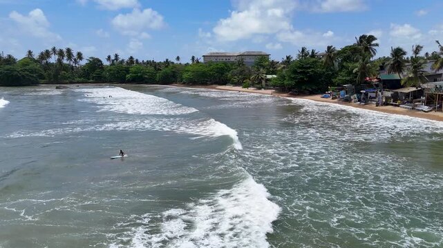 Galle, Sri Lanka, November 3, 2025: Devata Beach in the galle city and surfers riding in the waves