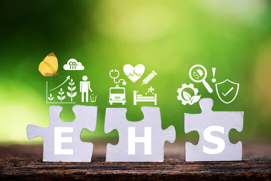 EHS text on paper jigsaw puzzle and icons on natural background.
