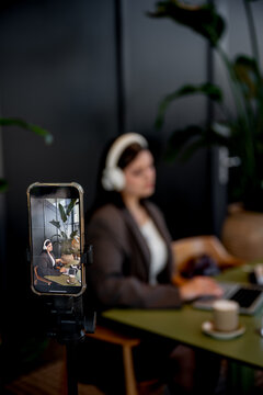 Businesswoman doing SMM work in a cafe setting