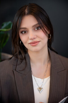 Businesswoman in a cafe setting with friendly demeanor