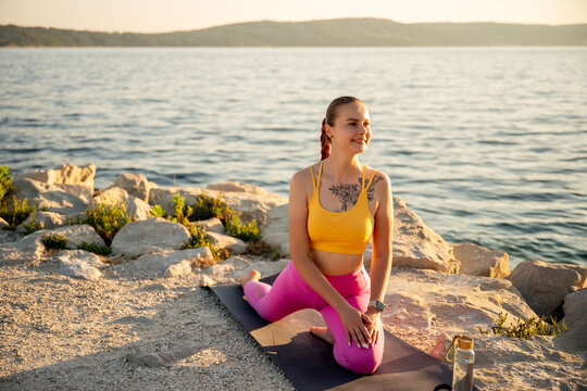 Woman practicing yoga by the sea for life balance
