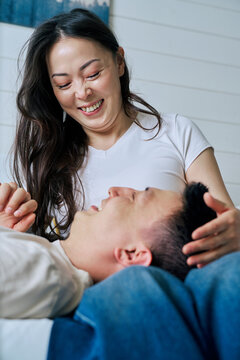 Couple sharing laughter and intimate indoor moment at home