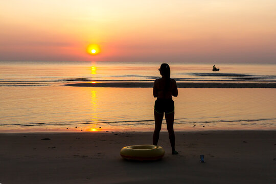 Woman with sunrise and silhouette
