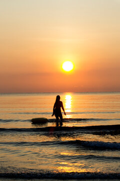 Woman with sunrise and silhouette