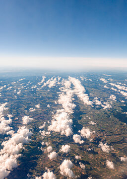 Aerial view of European countryside with clouds and haze