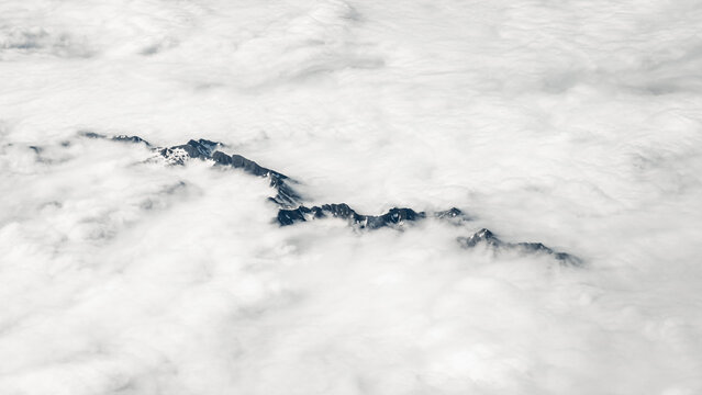 Aerial view of Pyrenees peaks above clouds, France Spain