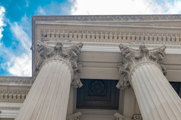 Monumental civic facade framed by Corinthian columns beneath blue sky in Washington DC © kosoff