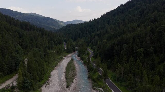 Aerial view of winding mountain road and alpine river in the Karwendel region near Eng Alm, Tyrol, Austria