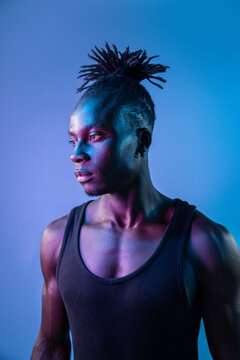 African man portrait with neon blue and purple light