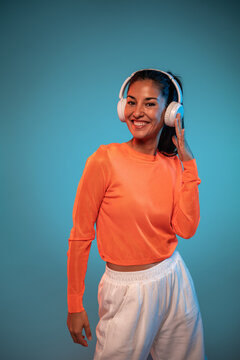 Latin woman dancer listen to music with headphones