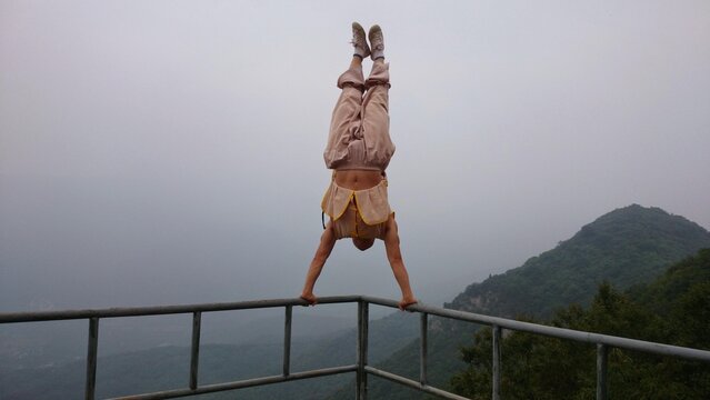 Shaolin Monk doing a handstand on the ledge.
Shaolin Temple Henan, China