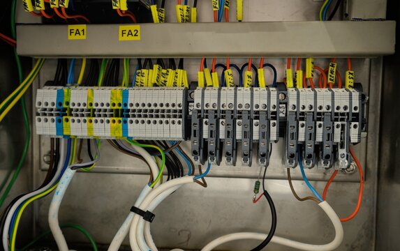 Industrial electrical control panel with terminal blocks and wiring inside a machine cabinet.