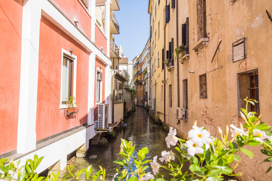 Narrow canal street between pastel buildings in Treviso