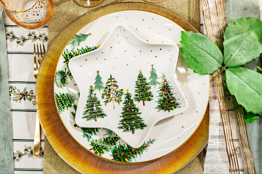 Christmas dinner table setting with festive holiday tableware