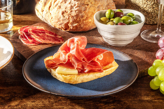 Rustic Mediterranean tapas with cured ham, bread and wine