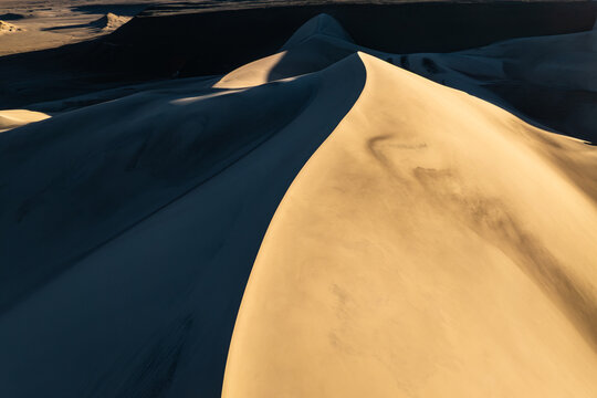 Golden sand dune ridge with shadow and abstract texture