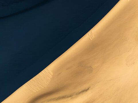 Abstract sand dune pattern with smooth golden texture background