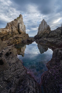 Asturian sea stacks reflected in a calm tidal pool