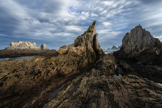 Rugged Asturian rocky coast and sea stacks under clouds