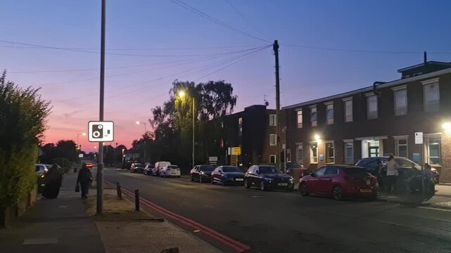 Low Angle Illuminated Streets View of Luton City of England United Kingdom During Orange Sunset Evening. Wide Angle Camera Footage Was Captured During Walk at Night of July 23rd, 2026.