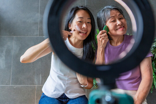 Mother and Daughter skincare routine with facial tools