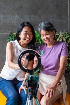 Chinese mother and Daughter filming gua sha tutorial video