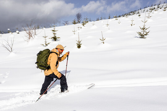 Splitboarder touring through deep powder snow in Japan