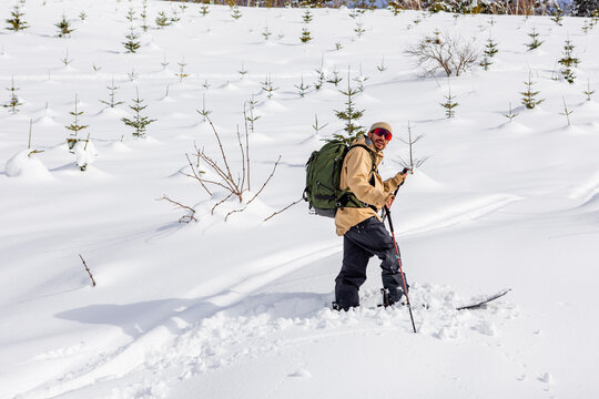 Splitboarder touring through deep powder snow in Japan