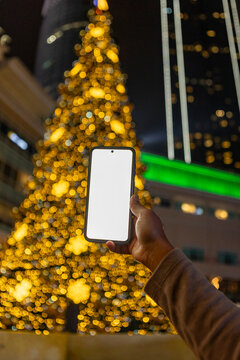 Smartphone mockup with bokeh Christmas tree lights, Malaysia