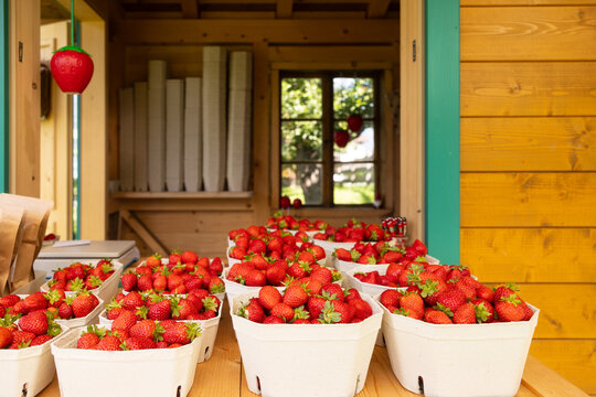 Fresh strawberries in cardboard boxes on a wooden table