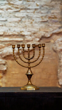 Brass menorah on rustic wall in Cordoba, Spain, Europe