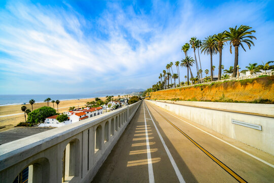 Scenic coastal road with palm trees overlooking the beach in Santa Monica, California