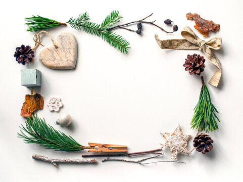 Christmas frame with spruce branches and ornaments, top view