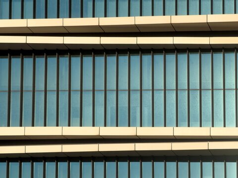 Modern glass facade of office building with window pattern