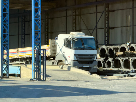 Cargo truck at steel warehouse with wire coil inventory