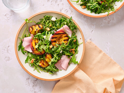 Grilled peach salad on a brunch table setting