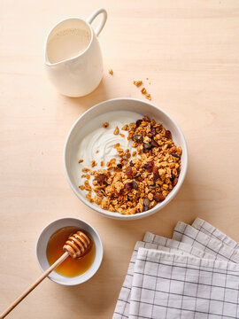 Delicious breakfast with homemade granola and honey