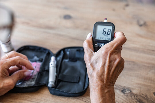 Blood sugar test with glucometer and lancet on table